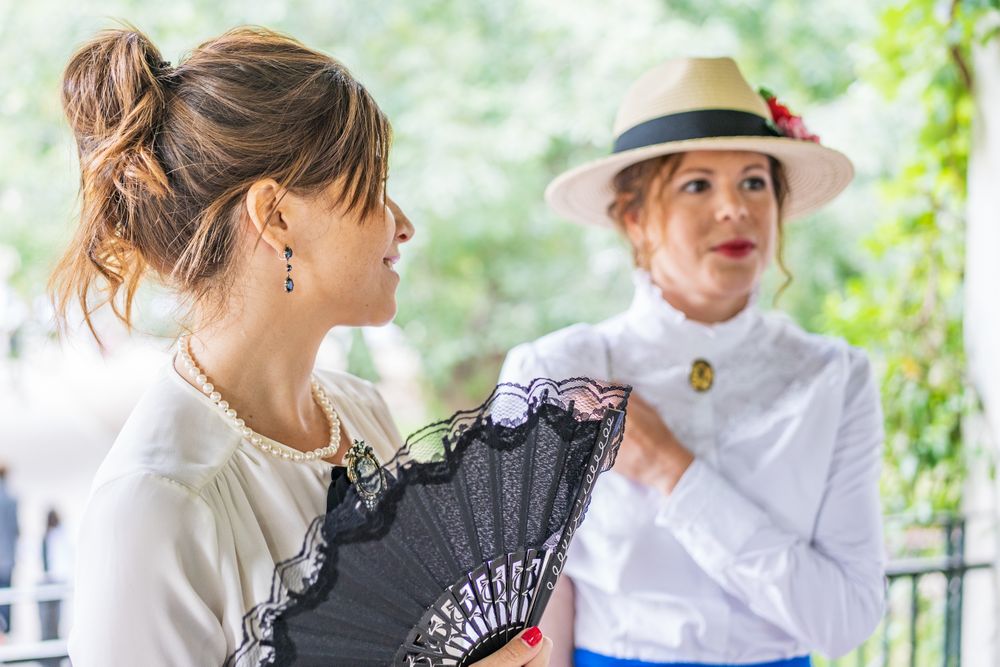 Vintage female friends speaking in garden