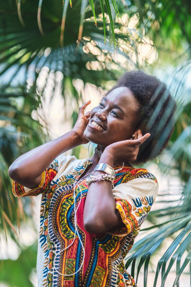 Smiling Black woman listening to music