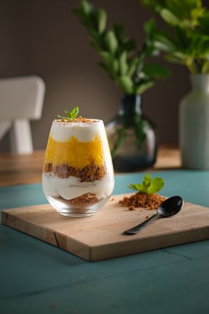 Sweet cheesecake in glass on table