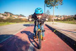 Front of little boy riding bike