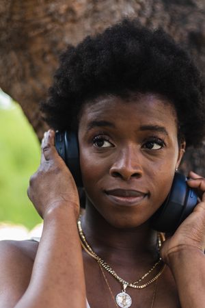 Black woman listening to music in headphones
