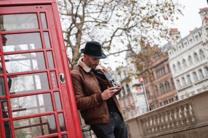 Male photographer near red telephone box