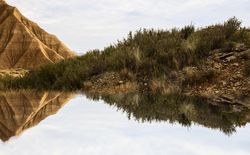Water near stone desert hills