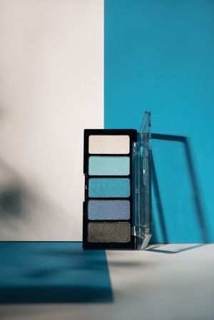 soft blue eyeshadow palette on geometric background.