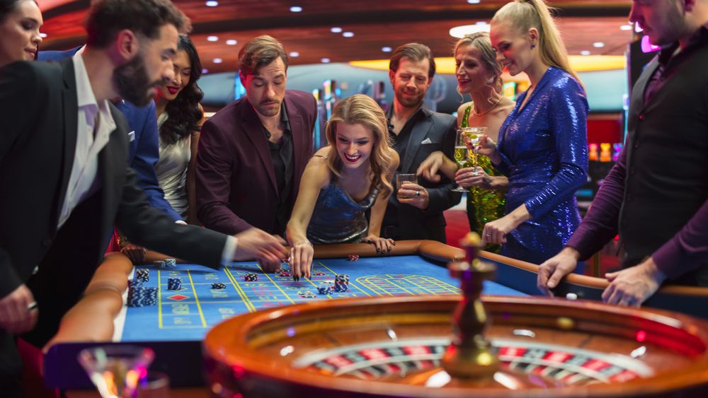 Female and Male Guests Placing Risky Bets while Playing Roulette.