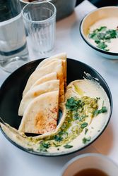 Table setting with water, pita bread and dip