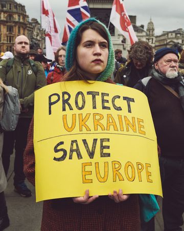 London, England, United Kingdom - March 5 2022: Woman with a “Protest Ukraine Save Europe” sign