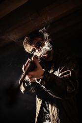 Man with shotgun and cigarette