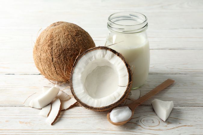 Coconut and milk on wooden background. Tropical fruit