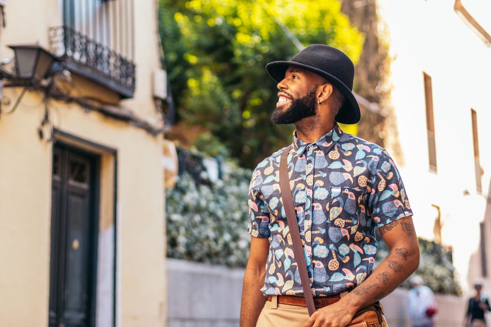Stylish Black man walking on the city street