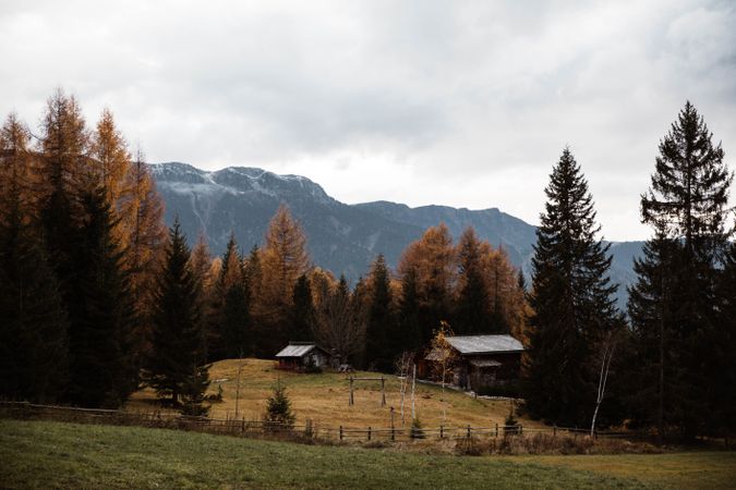 Lonely house in field by mountain