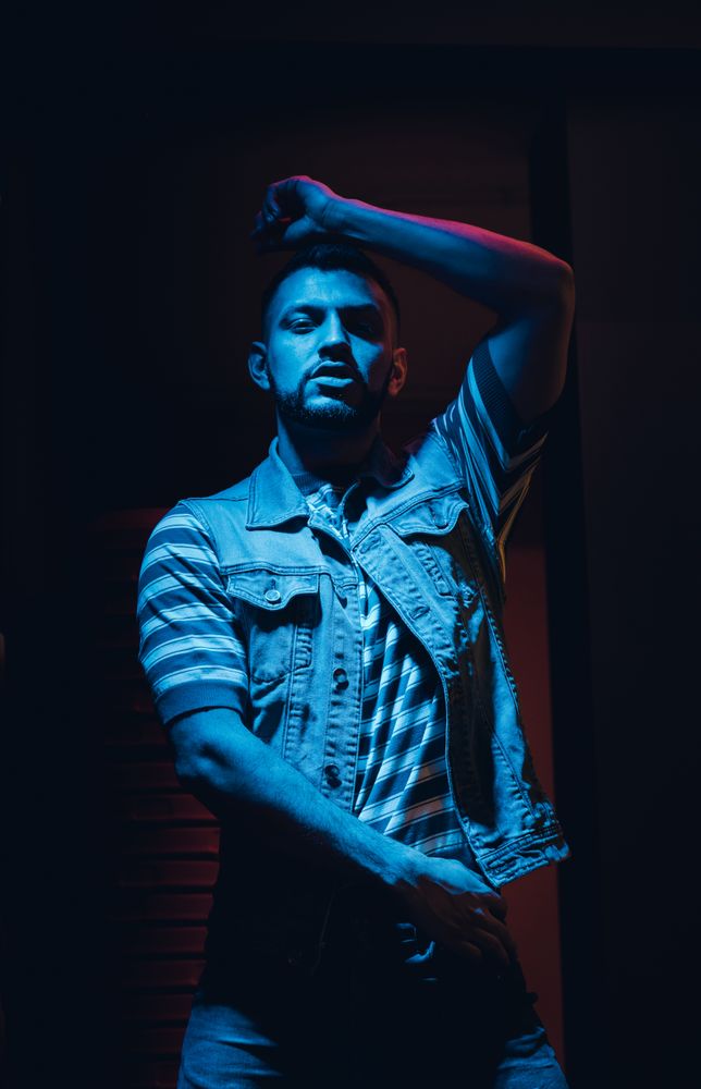bearded man dancing in spotlight