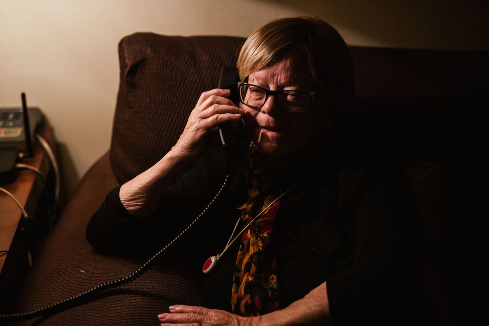 Pleased mature female talking on phone