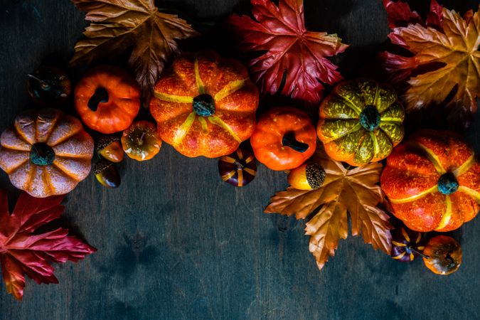 Fall flatlay with pumpkin decorations and leaves with space for text