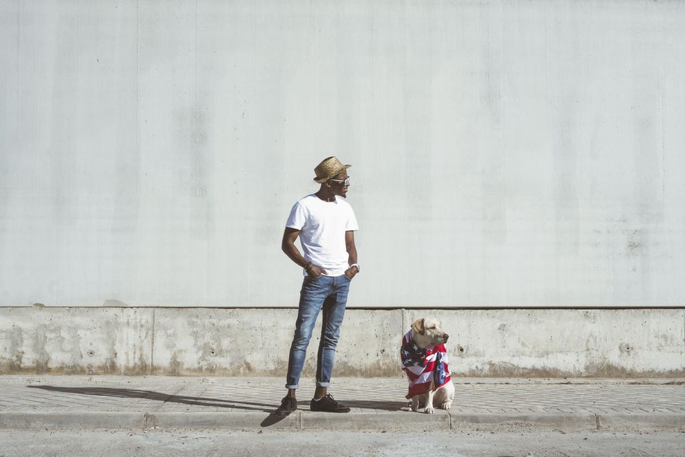 Man and dog in American flag on street