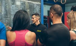 Coach explaining to athletes in the gym