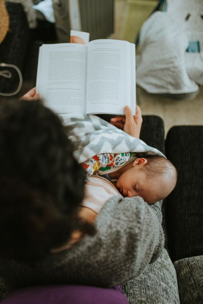 Top view of newborn sleeping with mom