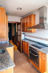 Kitchen on two fronts with wooden furniture