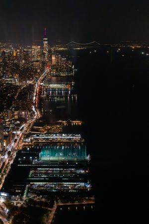 Aerial View of New York City. Helicopter Photo of a Big City with Skyscrapers Next to Port Area in New York City. Panoramic View with Highway Traffic