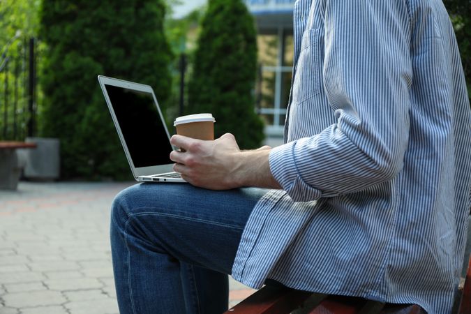 Young student working in a laptop and drinking coffee. Study. University