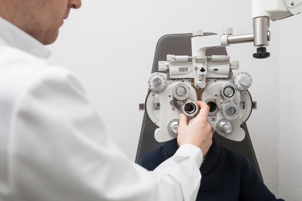 Optician testing a boy's eyes