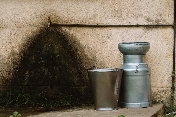 Metal containers near water tap on street