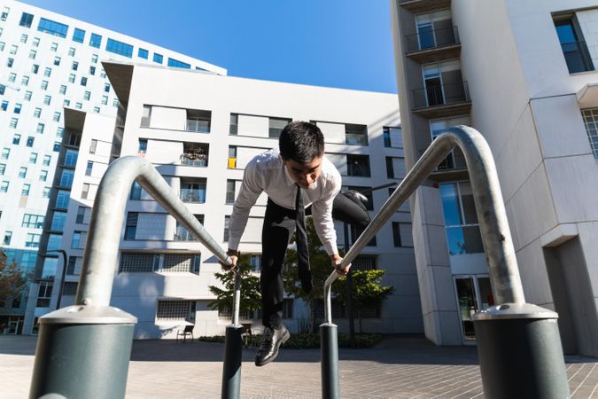 Businessman doing parkour in city district