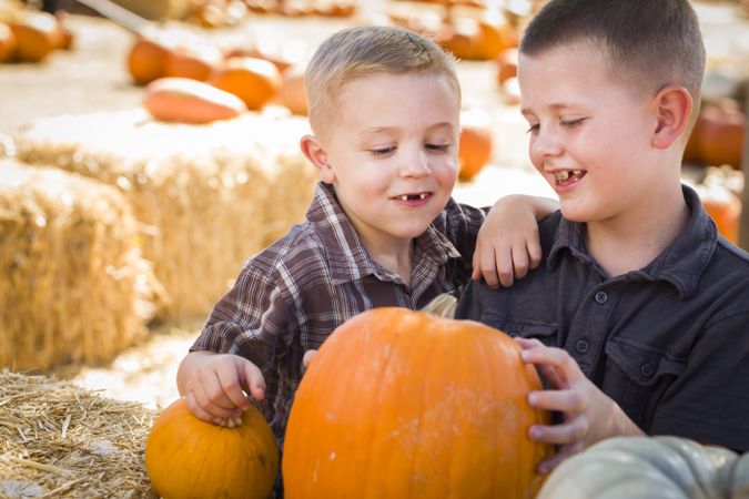 Two Boys at the Pumpkin Patch Talking and Having Fun.