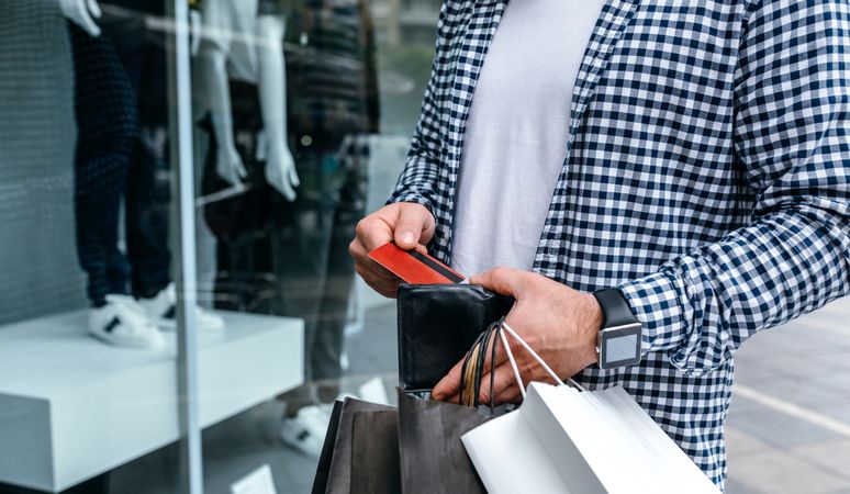 Man taking out credit card from wallet