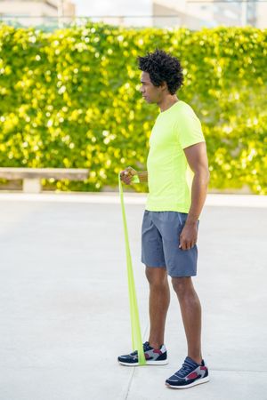Man exercising with resistance bands outdoors