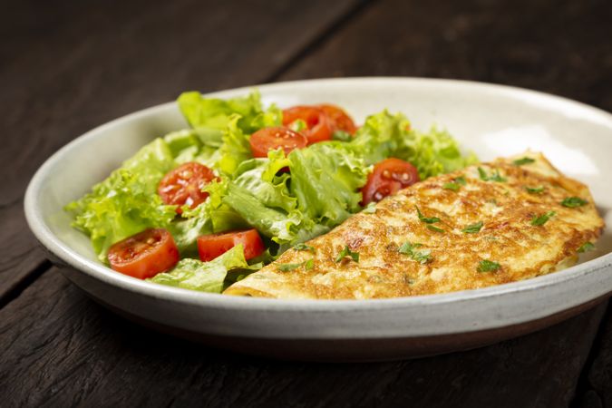Omelet with cheese and lettuce and tomato salad.