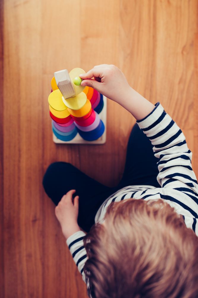 Boy playing with wooden construction pieces