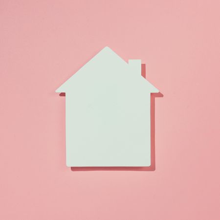 Paper house on pink background