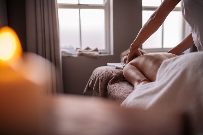 Woman having relaxing body massage in spa salon
