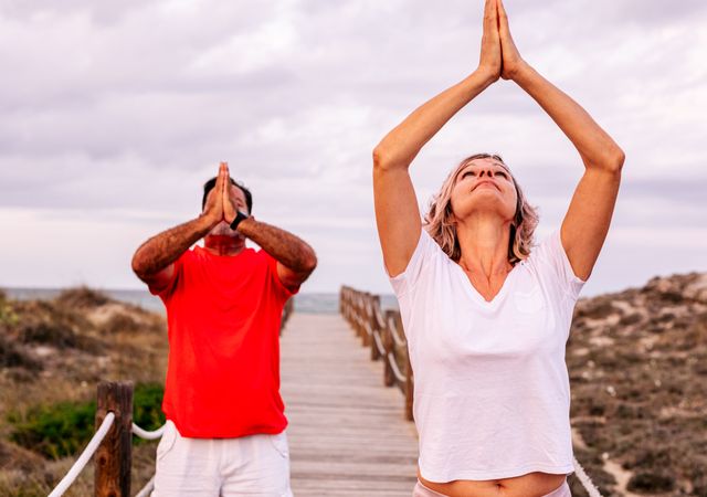 Couple practicing martial arts on lumber path