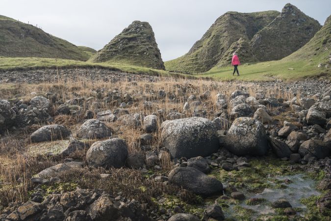 Woman walking along mountain river estuary