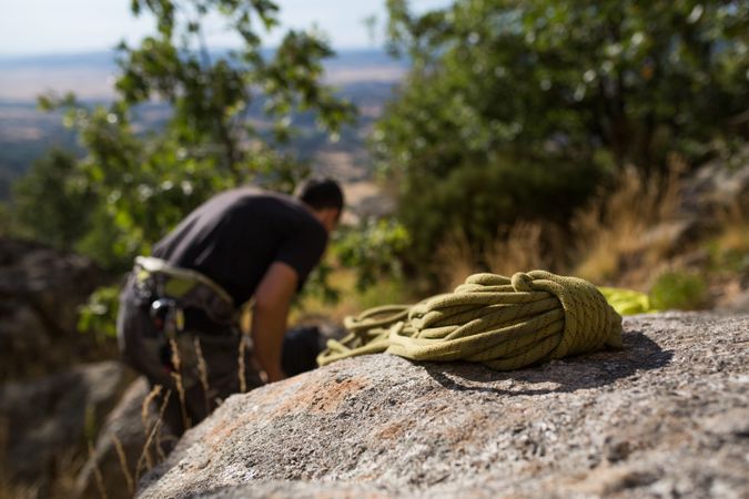 A climber is preparing his ropes to start climbing