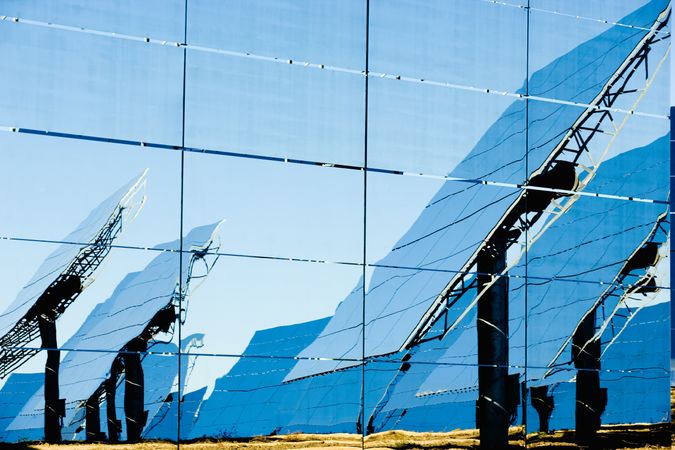 Reflection of solar panels on glass wall