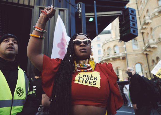 London, England, United Kingdom - March 19 2022: Black woman with a “All Black Lives” shirt