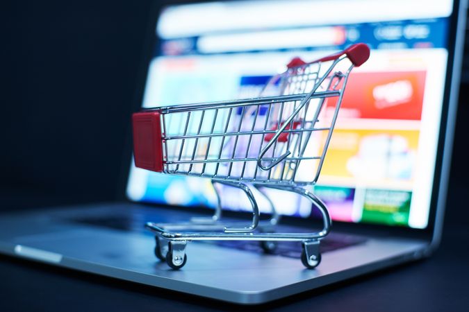 Shopping Cart Symbolizing Online Shopping on Laptop Screen