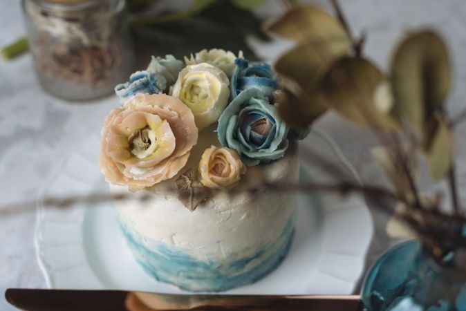 Buttercream flowers cake, blue and pastel peach colors