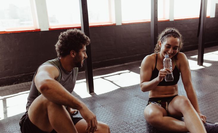 Couple relaxing after workout session at gym