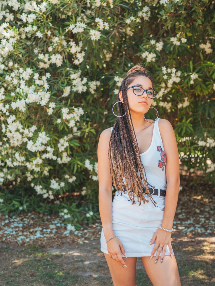 young female standing near blooming trees