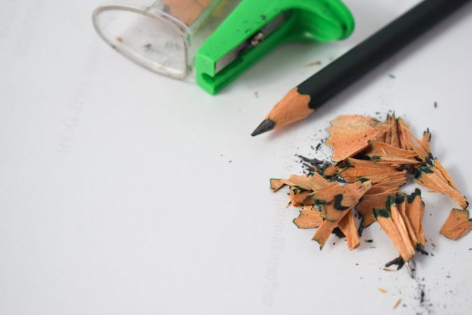 Pencil laying on table with shavings & sharpener