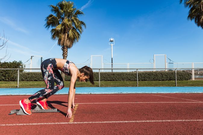 Athletic woman running on track