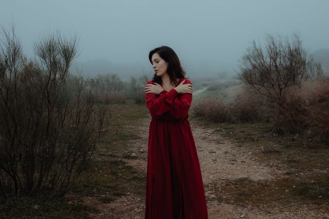 Woman in red dress walking in foggy area