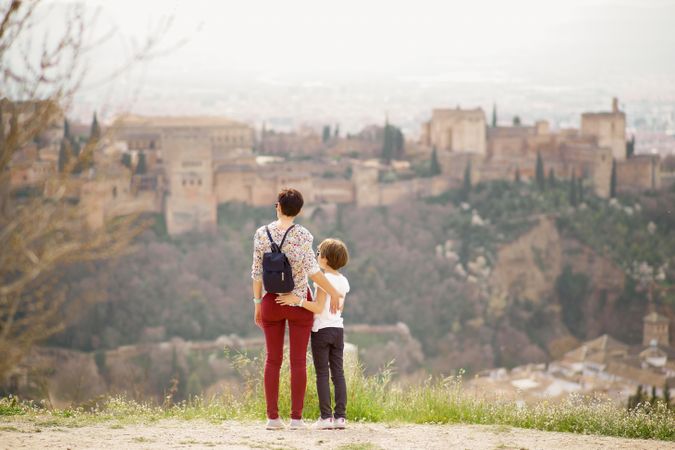 Mother and daughter overlooking beautiful Spanish town
