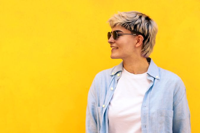 stylish young woman with short hair, sunglasses and hair wicks smiling. portrait