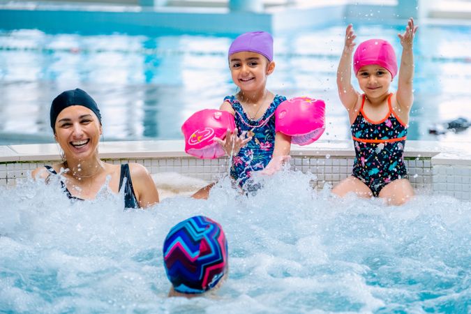 Family relaxing in bubbling pool