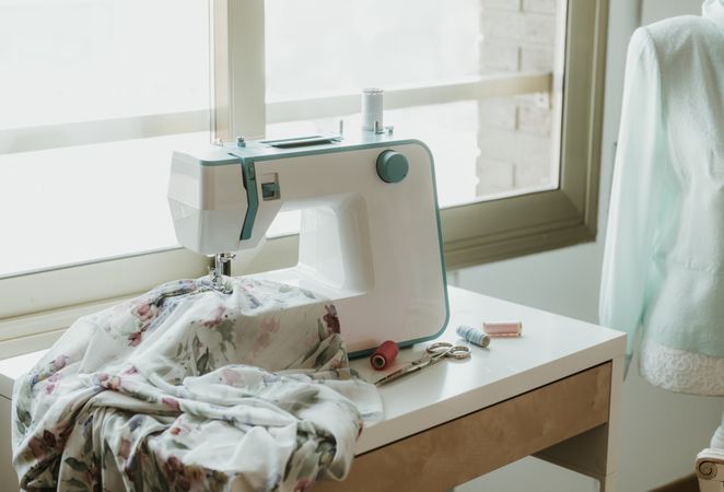 Dummy with blouse near sewing machine